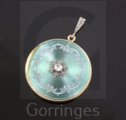 An Edwardian 18ct gold, guilloche enamel and diamond set circular pendant locket, with scroll