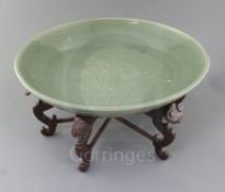 A Chinese Ming dynasty Longquan celadon dish, 15th century, with fine crazing to the glaze, the