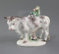 A Bow figure of a bull, c.1770-6, with white and grey markings, standing beside a blossoming tree,