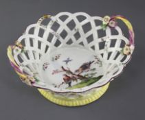 A rare early Derby basket, c.1756-7, the interior painted with two exotic birds perched on