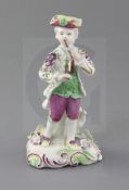 An early Derby 'Pale family' figure of a fife and drum player, c. 1756-8, playing a pipe and small