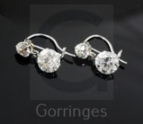 A pair of early-mid 20th century white gold? diamond drop earrings, each set with two graduated