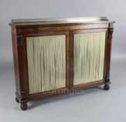 A Regency rosewood dwarf bookcase, with brass three quarter gallery and two silk pleated doors