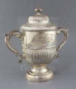 A late Victorian demi-fluted silver two handled pedestal presentation cup and cover, by John