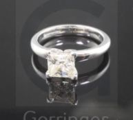 A modern 18ct white gold and solitaire princess cut diamond ring, the stone weighing approximately