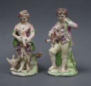 A pair of Derby groups of a boy and a girl, c.1770, the boy holding a puppy and the girl a lamb,