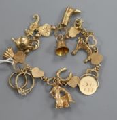 A 9ct gold charm bracelet, hung with eleven assorted charms including 9ct gold.