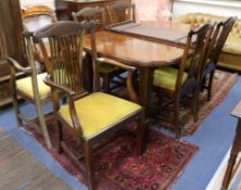 A 1920's extending mahogany extending dining table and a set of six chairs, two with arms