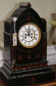 A Victorian aesthetic movement black slate and rouge marble 8-day mantel clock