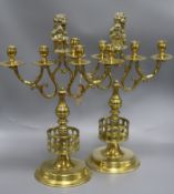 A pair of late Victorian cast brass four light candelabra