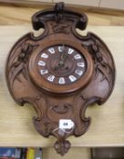 A carved walnut, Art Nouveau, wall clock 69cm long, 44cm wide