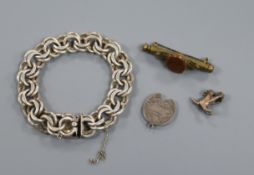 A silver double link bracelet, two white metal pendant charms and a 'goldstone' set metal brooch.