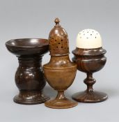 An early 19th century lignum vitae and ivory castor, 11cm, a treen castor, 13.5cm and a pounce
