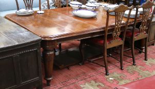 A Victorian mahogany extending dining table, with two spare leaves
