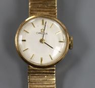 A lady's 9ct gold Omega manual wind wrist watch on 9ct gold Omega bracelet.