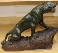 A J. Cartier, bronze model of a panther standing on a rocky base 44cm high, 57cm wide