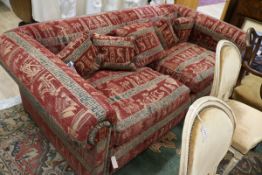 A very large two seater settee, upholstered with an Egyptian taste red, black and cream fabric W.