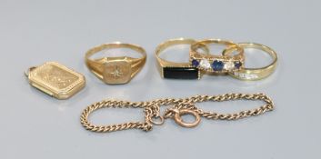 Four assorted 9ct gold and gem set rings, a 9ct gold locket and a 9ct small bracelet.