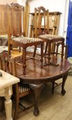 A 1920's mahogany circular extending dining table (two extra leaves) and four chairs W.141cm without