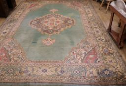 A Turkish green medallion carpet (worn in places and with one burn mark) 416cm x 300cm