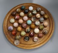 A large table solitaire board with sample hardstone balls Board 43cm diameter
