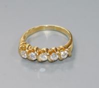 A yellow metal and five stone diamond half hoop ring, size O.