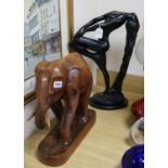 A plaster figure and a carved wood elephant