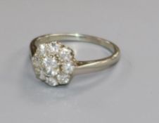 An 18ct white gold and diamond cluster flower head ring, size L.