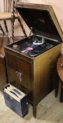 A 1920's HMV cabinet gramophone, with records and needles W.46cm