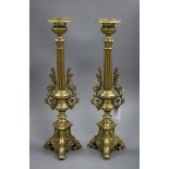 A pair of brass candlesticks 50cm high