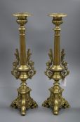 A pair of brass candlesticks 50cm high