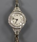 A lady's diamond set platinum cocktail watch on an 18ct gold bracelet.