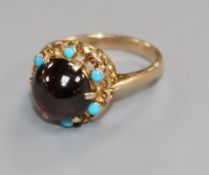 A 9ct gold, cabochon garnet and turquoise dress ring, size N/O