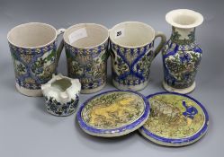 A group of Persian fritware vessels including three mugs, a vase, two stands, etc. Tallest 19cm