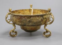 A George V silver gilt tri-handled floral embossed circular bowl by Daniel & John Welby, London,