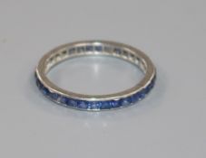 A white metal and sapphire set full eternity ring, size O.