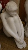 A small resin marble effect figure of a seated girl H.51cm