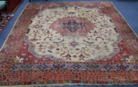 A Turkey pink and cream medallion carpet (worn in places and frayed at one end) 410 x 313cm