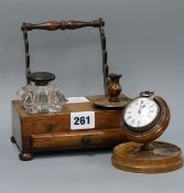 A 19th century treen pocket watch holder with late 18th century brass cased verge pocket watch and a