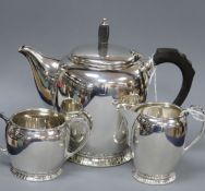 A silver three-piece tea service of oval form with panelled foot rims, gross 26.5 oz.