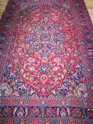 A Tabriz style red and blue ground carpet