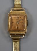 A lady's 18ct gold Ancre manual wind wrist watch, on a gilt metal bracelet.