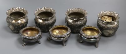 A set of four plated embossed vases and a set of three circular plated salts