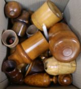A group of Victorian and later treen including cased glass vessels, a cup holder and dice cups