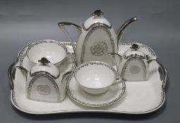 An Art Deco silver and white decorated tea for two