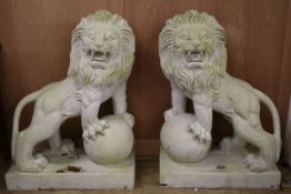 A pair of resin marble effect lion and orb garden ornaments W.70cm at base