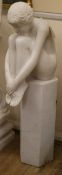 A resin marble effect figure of a seated girl H.106cm