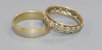 A two colour 18ct gold band and a 9ct gold and gem set ring.