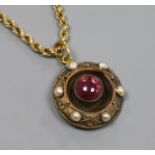 A Victorian yellow metal, cabochon garnet and split pearl set circular pendant, on a later 9ct