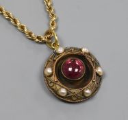 A Victorian yellow metal, cabochon garnet and split pearl set circular pendant, on a later 9ct